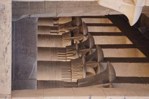 Close-up of ancient stone columns with intricate carvings.