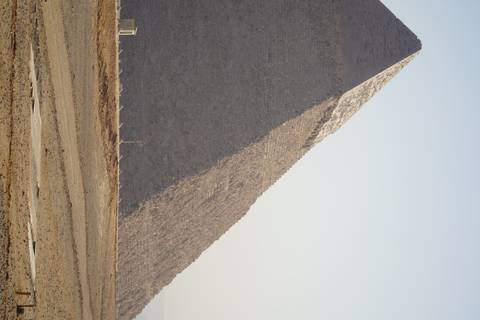 Partial view of a Pyramid in a desert.