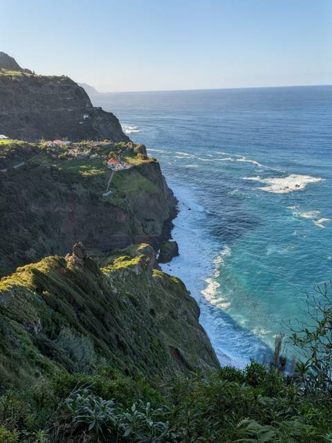 Aerial view of rocky cliffs along the ocean shore.