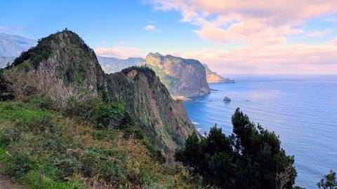 A dramatic coastal landscape with cliffs and the ocean.