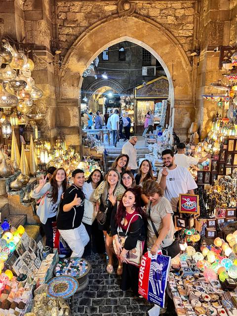 A group of people exploring a vibrant market.