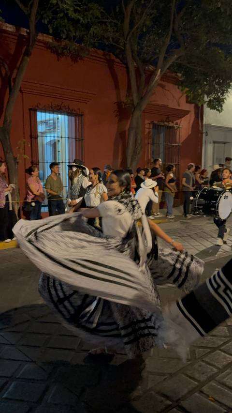 Dancer twirling in costume during a parade.