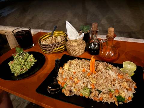 Plate of food with guacamole and drink.