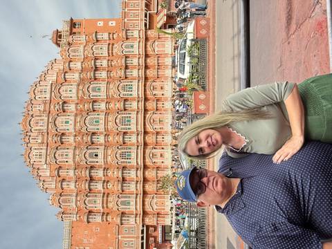 Two people posing in front of the Hawa Mahal.