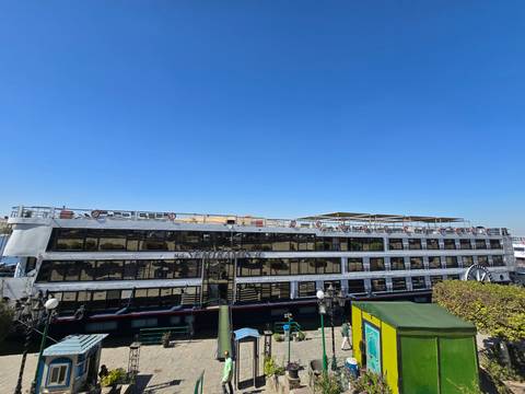 Large river cruise ship docked at a port.
