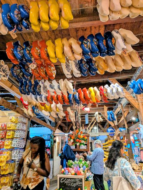 Traditional wooden shoes displayed indoors, vibrant colors.