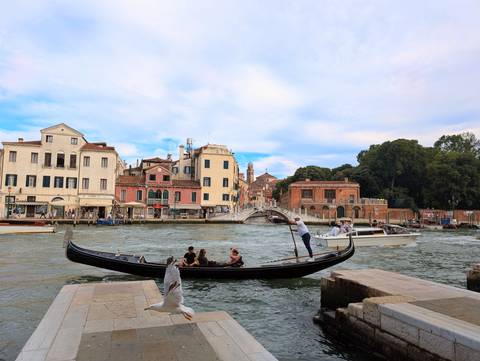 Gondola on a canal with historic buildings in Venice.