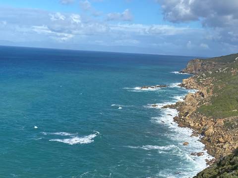 Rocky coastline with waves crashing against the shore.
