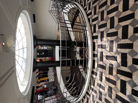 Interior of a cruise ship with decorative features and a view of the deck area.