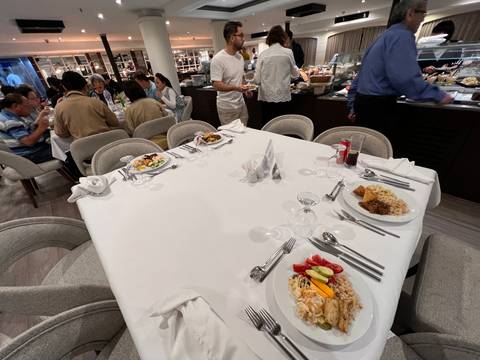 Dining area with a group of people enjoying a meal.