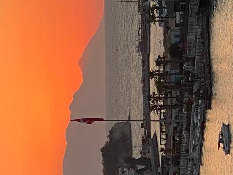 Silhouette of a landscape at sunset with sea view.