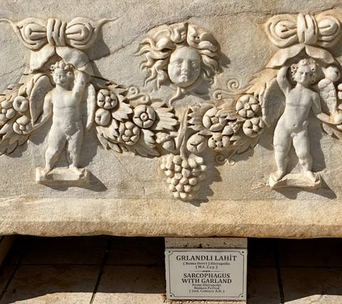 Detailed stone carving with angelic figures.