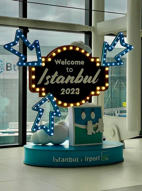 Welcome to Istanbul 2023 sign in a modern space.