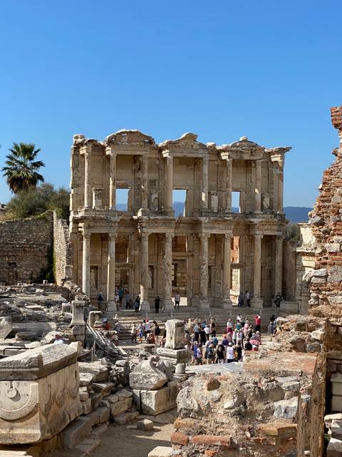 The facade of the ancient Celsus Library with visitors.