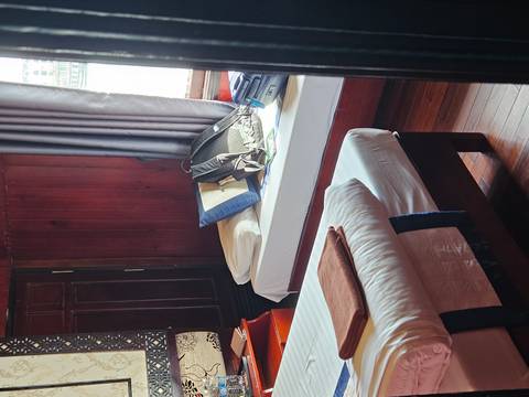 Interior of an accommodation with bed and luggage.