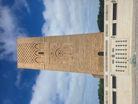 A tall, brown historic tower against a blue sky.