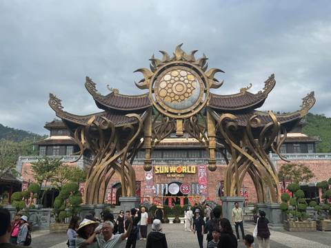 Entrance to Sun World with architectural features and cloudy sky.