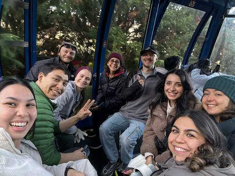 Group of people in a cable car enjoying a scenic ride.