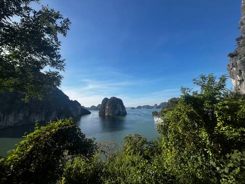 A beautiful view of islands from a lush green hilly vantage point.
