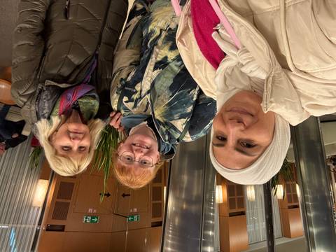 Three people taking a selfie in a lobby.