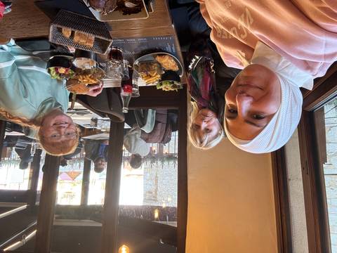 Three people dining at a restaurant.