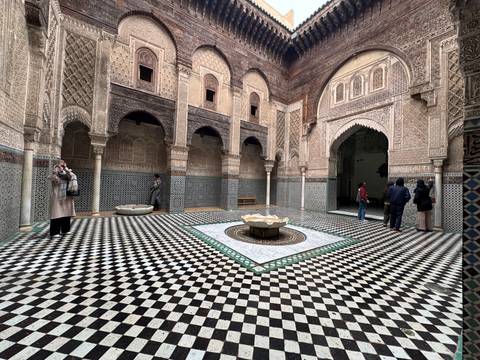 Ornate courtyard with people exploring.
