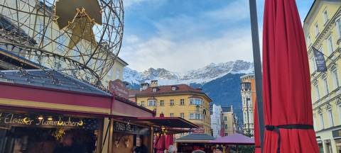 Winter market with mountains in the background.