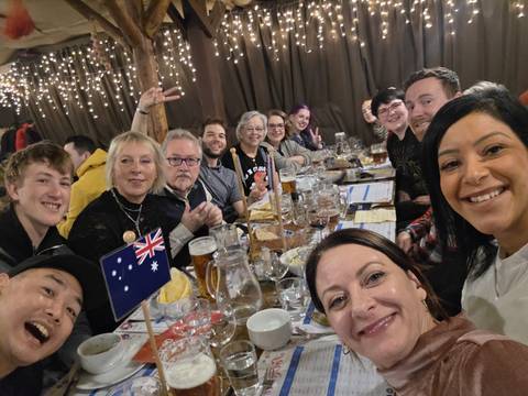 Group of tourists dining with festive atmosphere.
