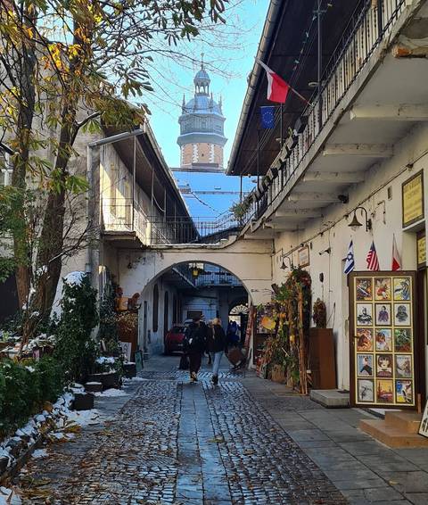 Outdoor corridor with decorated balconies and shops.