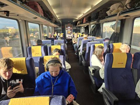 Interior view of a train cabin with passengers.