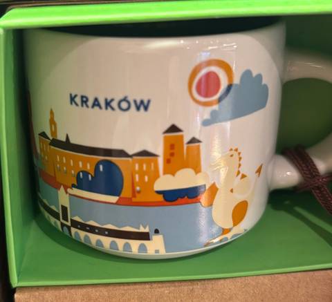 Close-up of a souvenir mug with Krakow design.