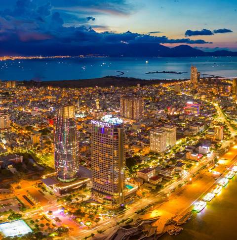 Cityscape at night with illuminated buildings and river