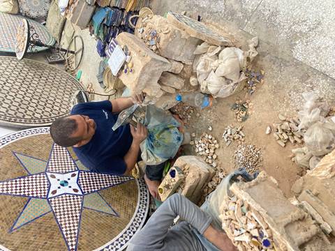 Artisan working on mosaics and stones.