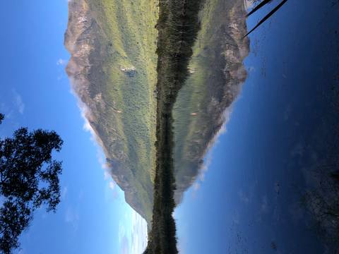 Mountains reflecting off the surface of a clear lake.