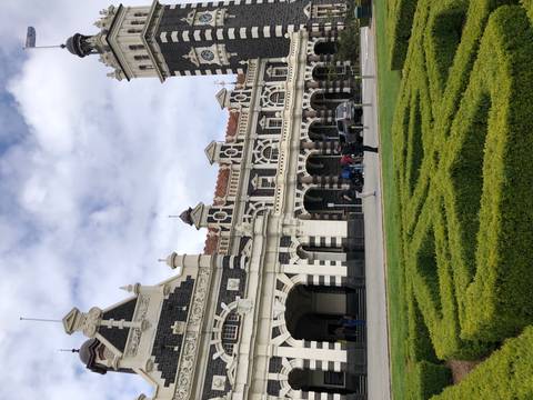 Black and white historic railway station with intricate architecture.