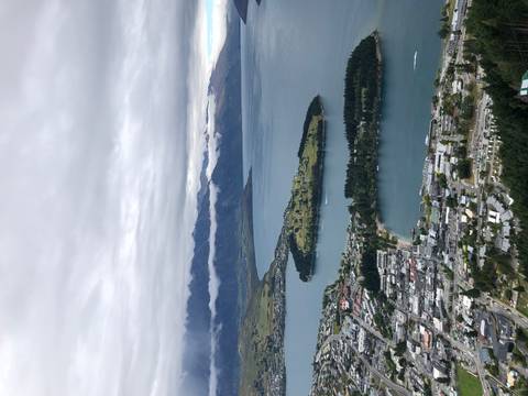 Town with lakeside views and surrounding mountains.