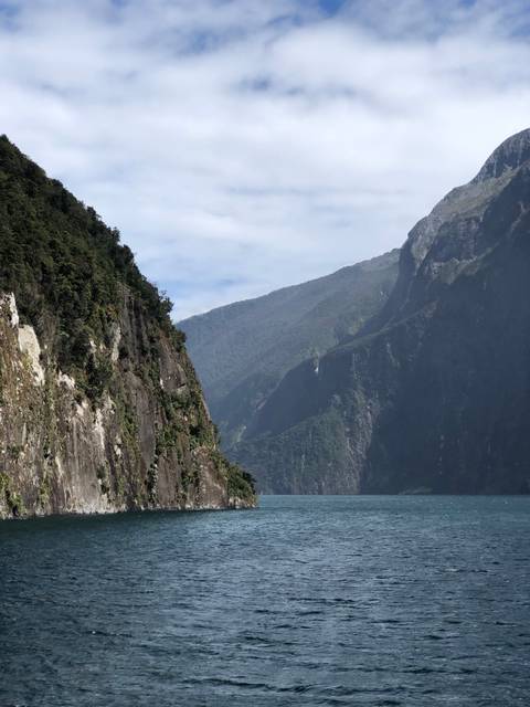 Massive cliff faces with dense vegetation.