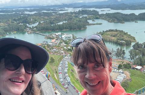 Two women with a scenic view from a height.