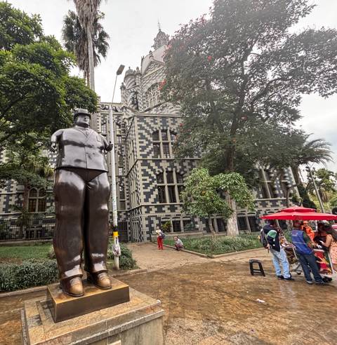 Botero sculpture in front of a historic checkerboard building.