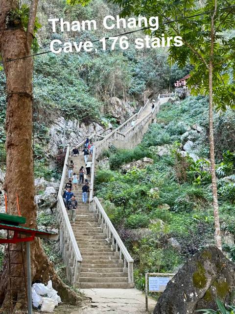 Stairs carved into a mountainside with tourists climbing.