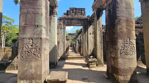 Stone temple ruins with carvings and columns.