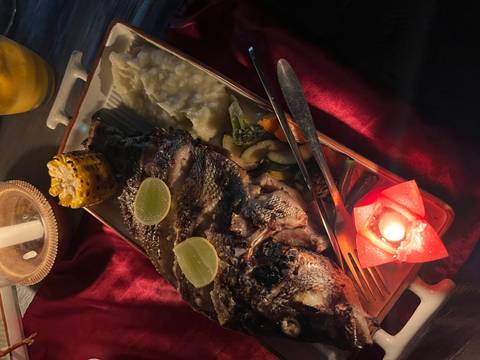 Grilled fish served with vegetables and masala.