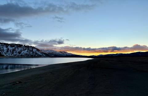 Serene lake view with sunset in the mountains.