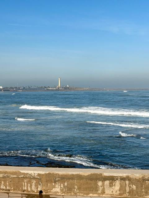 Ocean view with a lighthouse in the distance.
