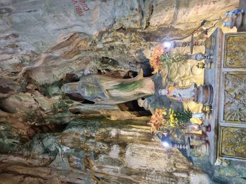 Religious statue in a stone cave shrine.