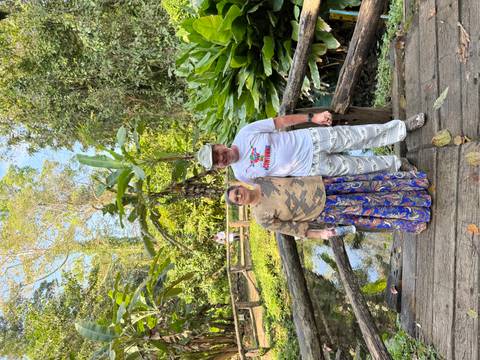 Couple enjoying a walk in a lush botanical garden.