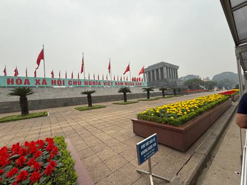 Man-made monument and garden with Vietnamese flags.