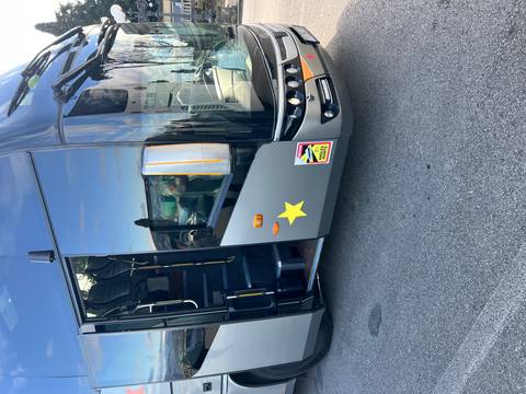 Tour bus parked on the road with a scenic view.