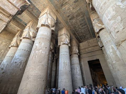 Interior hall of an ancient temple with decorated columns.