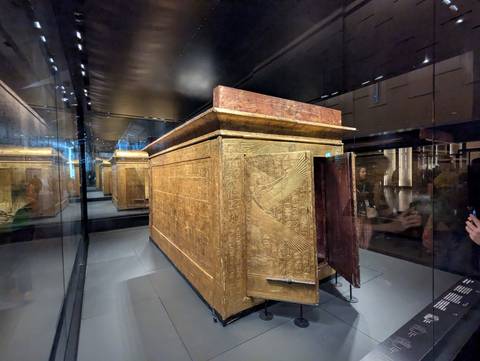 Intricate sarcophagus on display in a museum.